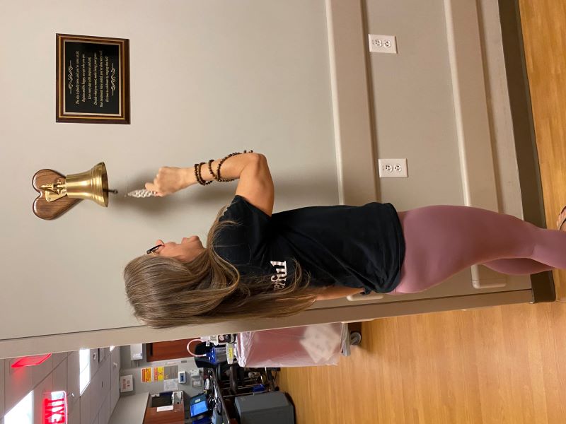 Briana Eacott rining the end of treatment bell.jpg